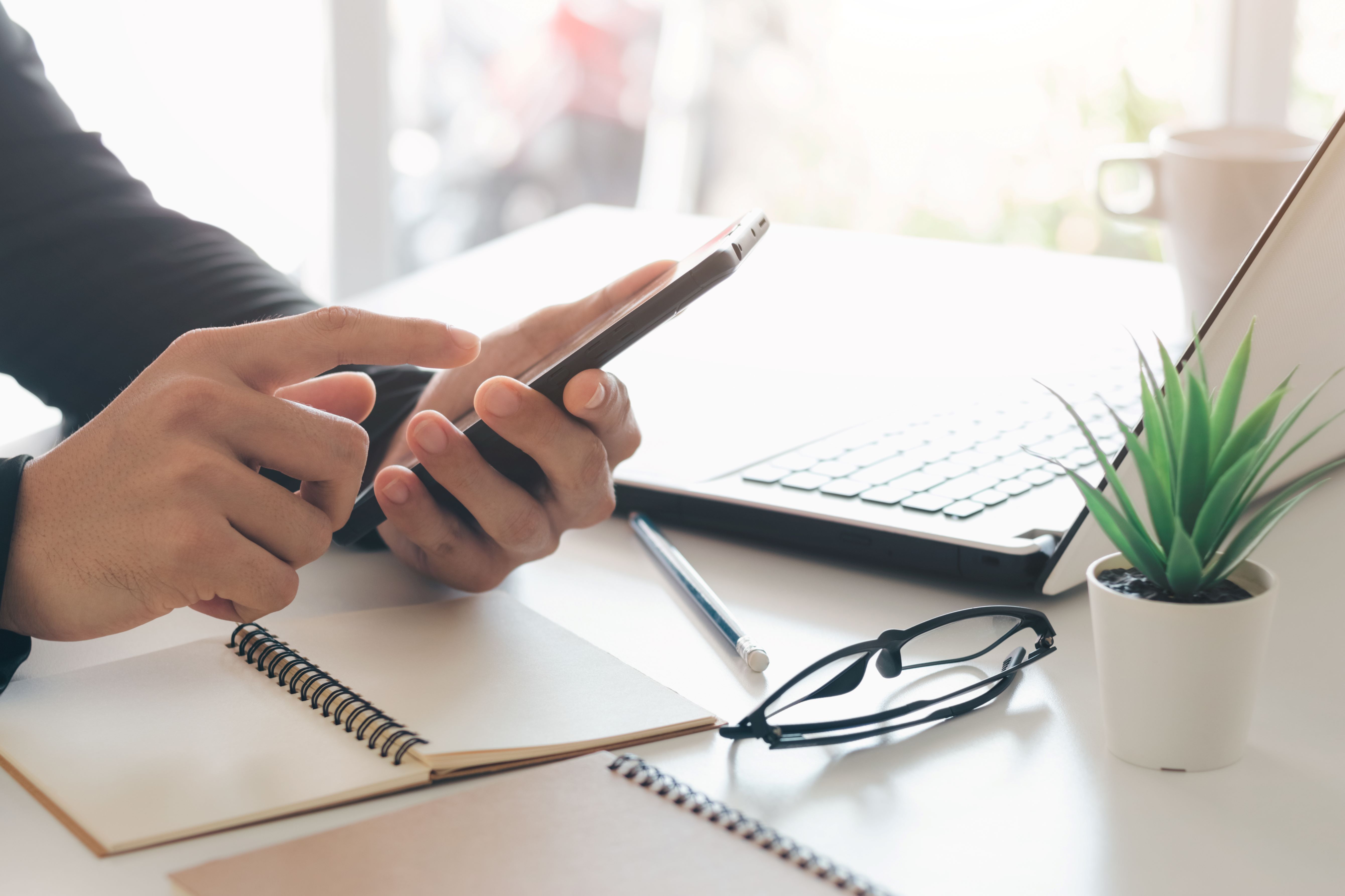 Work using mobile phone typing computer mobile chat laptop contact us at workplaces